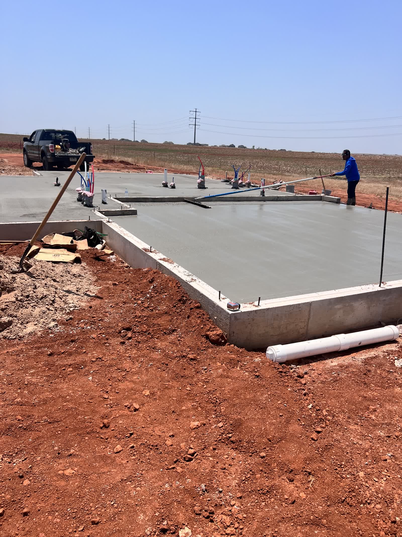 Residential foundation pour in Piedmont, Oklahoma — fresh slab on Oklahoma red clay subgrade